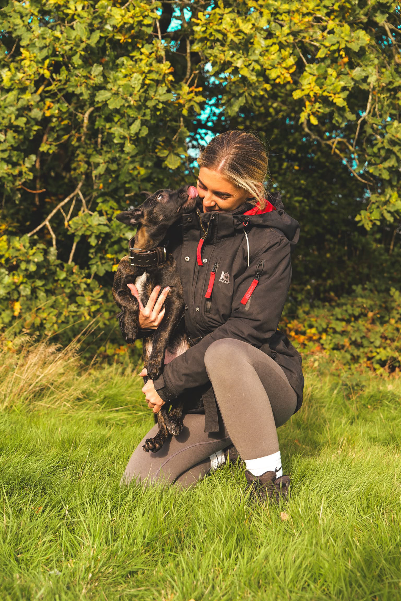 A puppy licking Holly's face